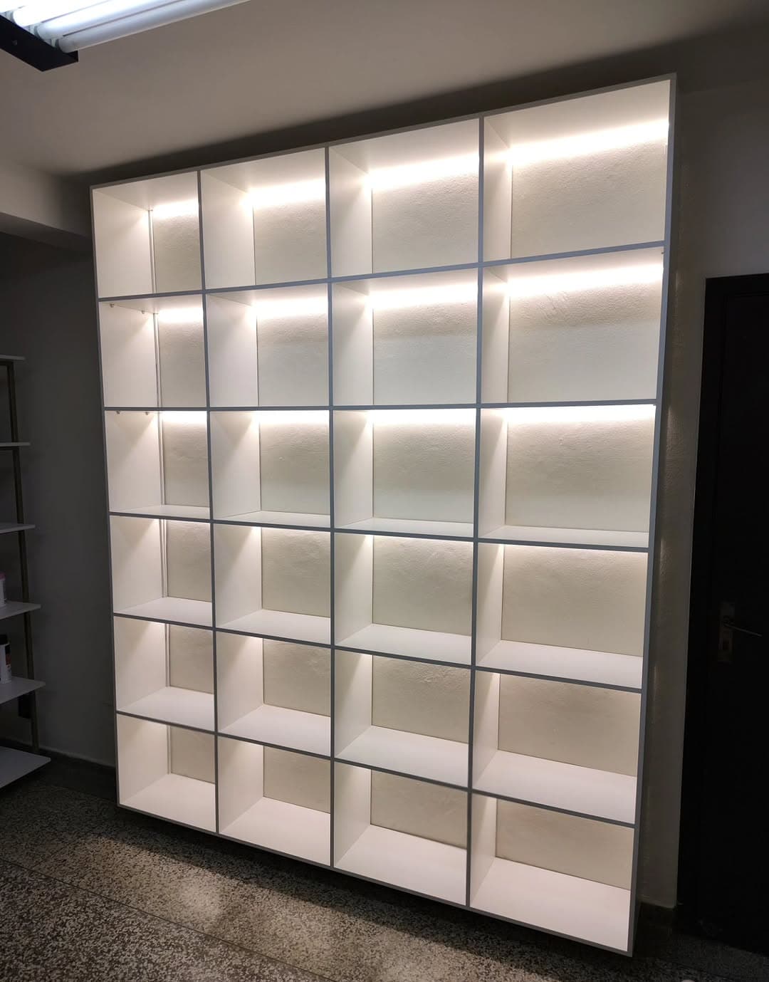 Estante expositora de nichos brancos com iluminação em LED